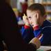 Wines Elementary School kindergardener Shane Roberts, 5, covers an eye as he concentrates on a spelling exercise during class at the school on Friday afternoon. Melanie Maxwell I AnnArbor.com